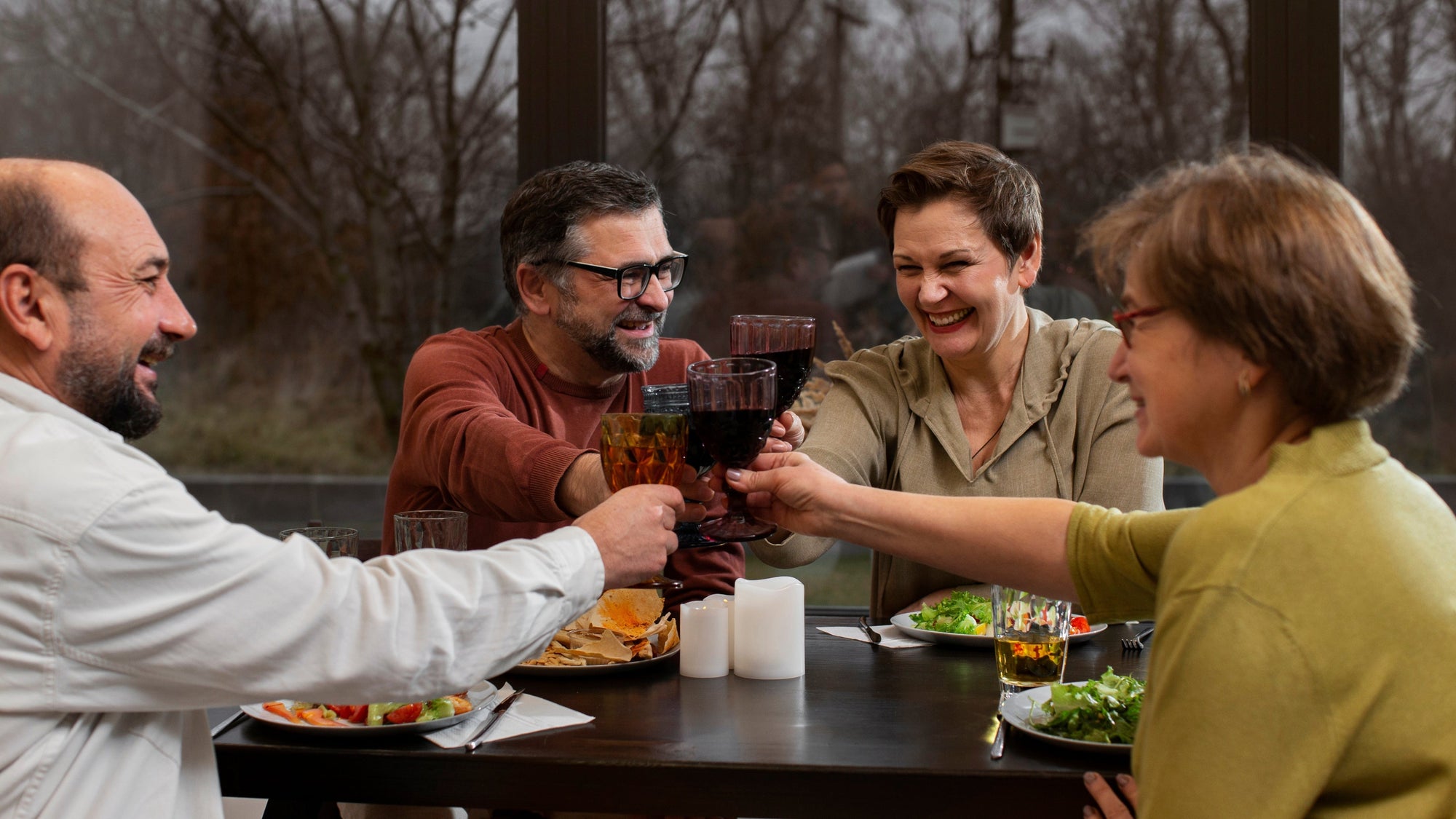 Friends clinking glasses during a relaxed dinner gathering